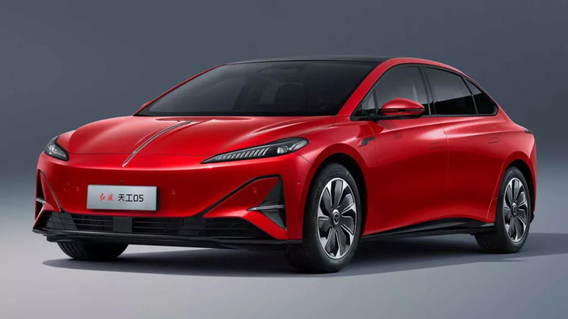 Red electric sedan on a studio background